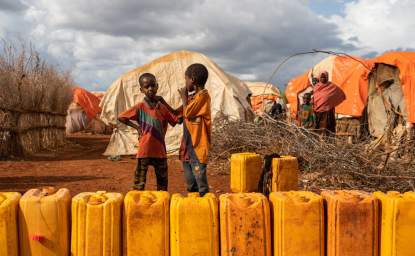 Children standing in line to fill water and yellow drums in Baidoa, Somalia, 2019.  Shutterstock