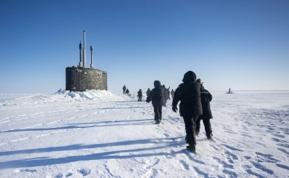 Chief of Naval Operations Adm. Lisa Franchetti walks with other distinguished visitor towards the Virginia-class fast-attack submarine USS Indiana (SSN 789) before embarking Indiana during Operation Ice Camp (ICE CAMP) 2024.