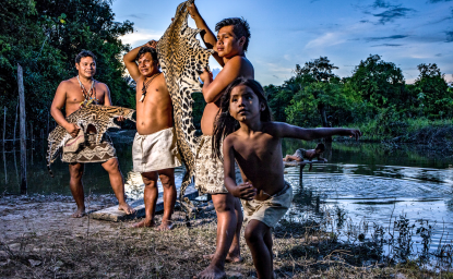 Members of the Boras Communidad, a Peruvian Indigenous group, with a jaguar skin from a cat they’d poached.