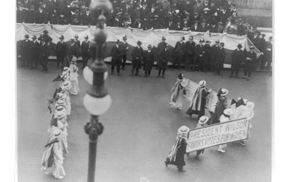 Suffragettes parading with banner "President Wilson favors votes for women". N.Y.C. , ca. 1916. Photograph. https://www.loc.gov/item/2001704196/.