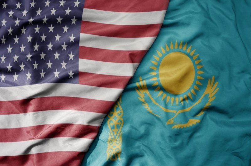 big waving flag of united states of america and national flag of kazakhstan