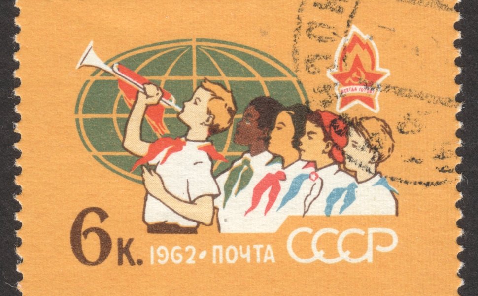  CIRCA NOVEMBER 2018: a post stamp printed in the USSR shows Pioneers of Different Peoples, Globe, the series "The 40th Anniversary of All-Union Lenin Pioneer Organization", circa 1962