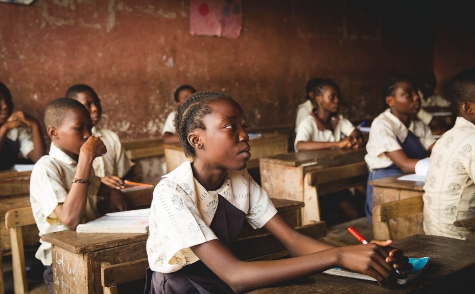 children sitting on chairs inside classroom