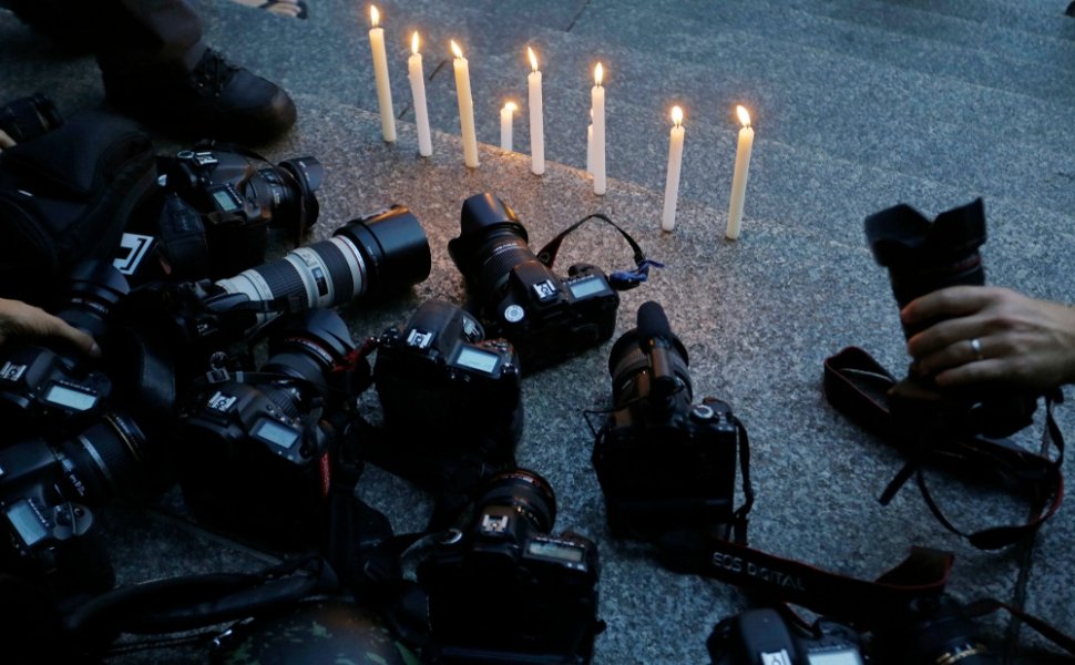 Cameras at a candlelight vigil