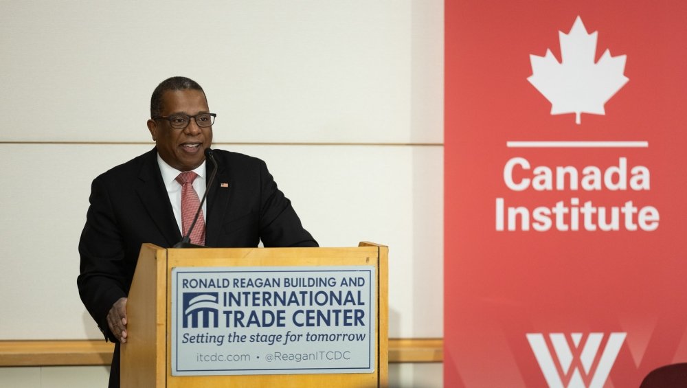 Brian Nichols with Canada Institute Banner